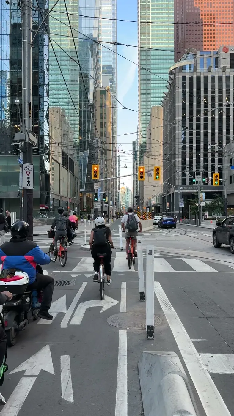 Cyclists travelling through a downtown Toronto intersection