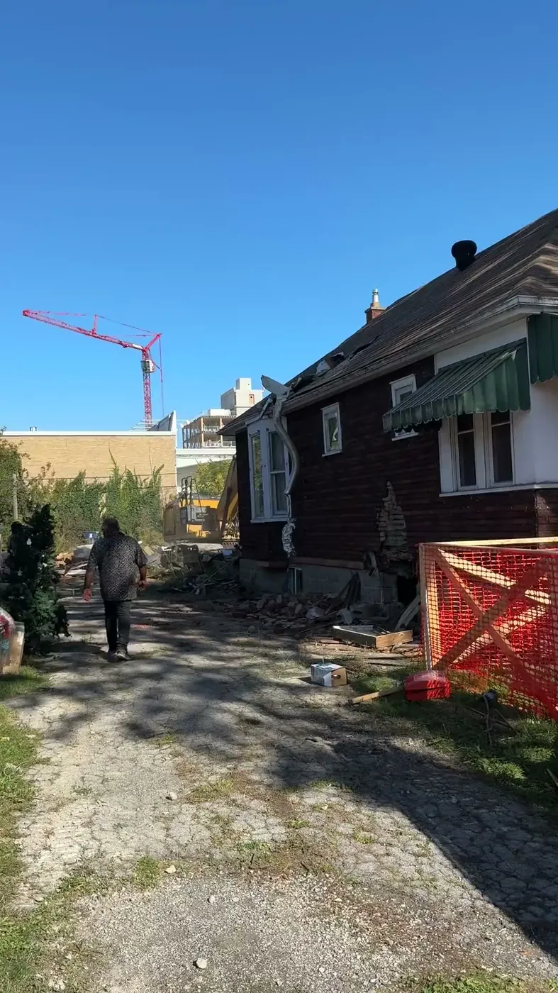 An older Toronto house being carefully dismantled before new construction